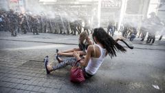 Riot police use a water cannon to disperse LGBT rights activist before a Gay Pride Parade in central Istanbul, Turkey