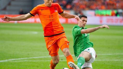Holandský fotbalista Arjen Robben se s míčem vyhýbá Oliveru Norwoodovi ze Severního Irska v přípravném utkání na Euro 2012.