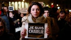 Woman holds a placard during a vigil to pay tribute to the victims of a shooting by gunmen at the offices of weekly satirical magazine Charlie Hebdo in Paris, at Trafalgar Square in London
