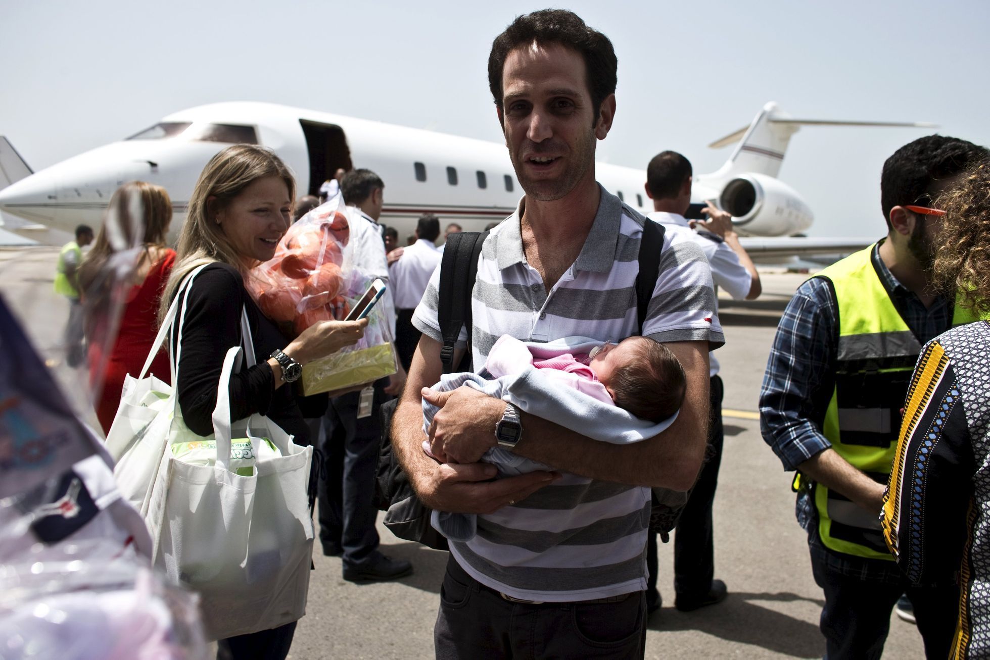 An Israeli man holds his baby, born to a surrogate mother, in Tel Aviv