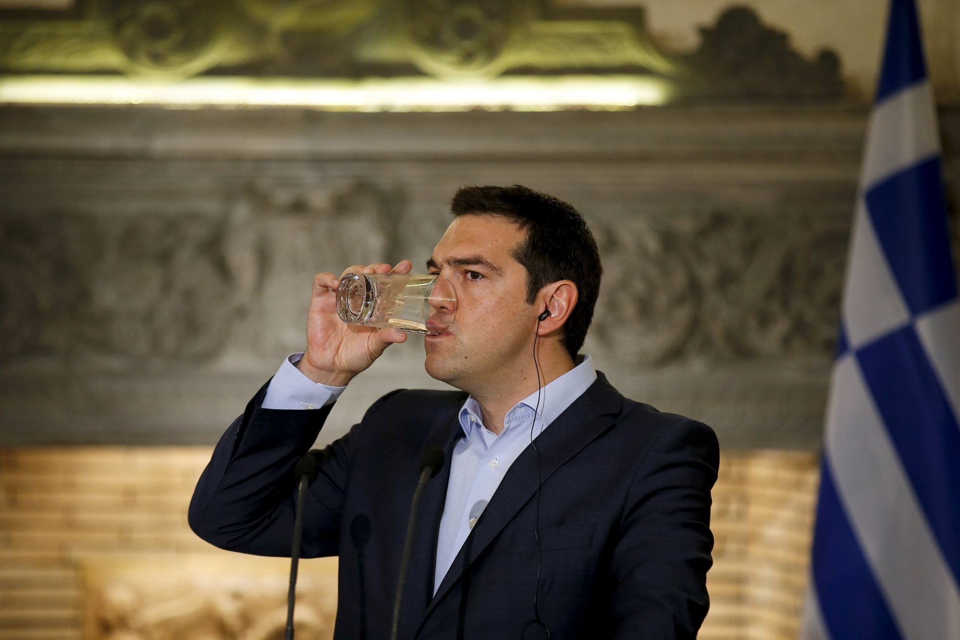 Řecko Tsipras Greek PM Tsipras takes a drink during a news conference in Athens