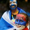 Supporters of Djokovic of Serbia and Murray of Britain smile before the start of the men's singles final match at the Australian Open 2015 tennis tournament in Melbourne