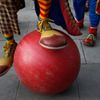 A clown attempts to balance on a large ball outside the All Saints Church before the Grimaldi clown service in Dalston, north London