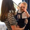 Britain's Prince George plays with his mother Catherine, the Duchess of Cambridge's hair, during a Plunket play group event at Government House in Wellington