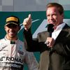 Race winner Mercedes Formula One driver Lewis Hamilton of Britain stands next to actor Arnold Schwarzenegger during the podium ceremony of the Australian F1 Grand Prix at the Albert Park circuit in Me