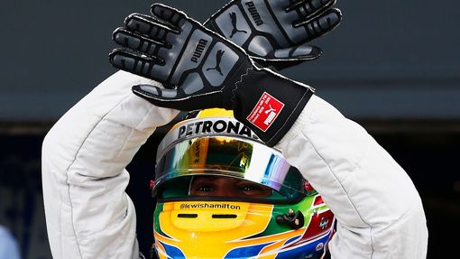 Mercedes Formula One driver Lewis Hamilton of Britain celebrates taking pole position for the final during the qualifying session for the British Grand Prix at the Silver