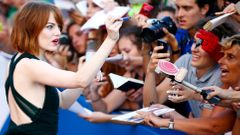 U.S. actress Stone signs autographs during the red carpet for the movie &quot;Birdman or (The unexpected virtue of ignorance)&quot; at the 71st Venice Film Festival
