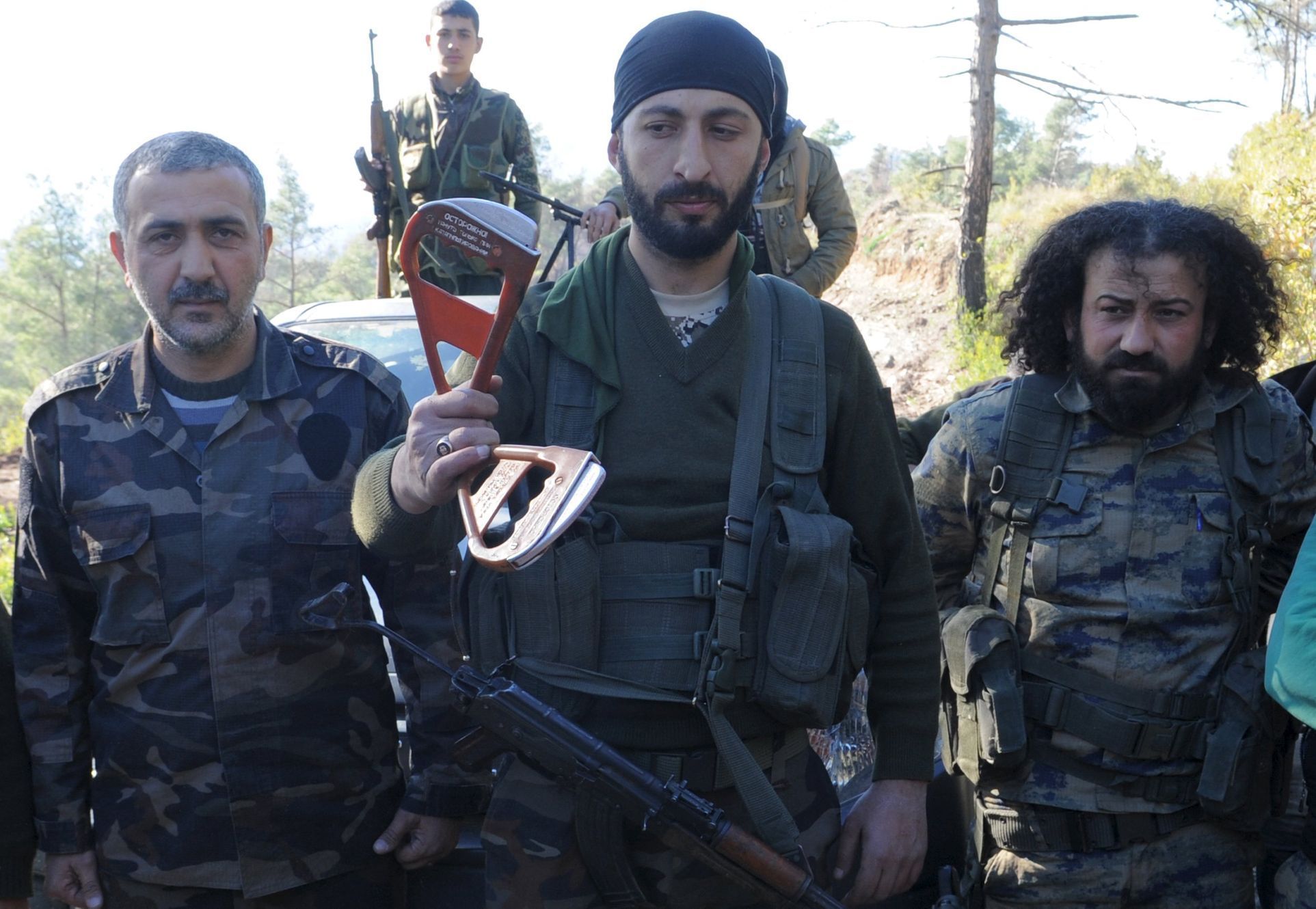 Alpaslan Celik, zástupce velitele syrských Turkmenů, drží řídící kolíky padáků, které patřily ruským pilotům.