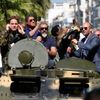 Cast members Sylvester Stallone, Mel Gibson, Jason Statham and Harrison Ford pose on a tank as they arrive on the Croisette to promote the film &quot;The Expendables 3&quot; during the 67th Cannes Fil