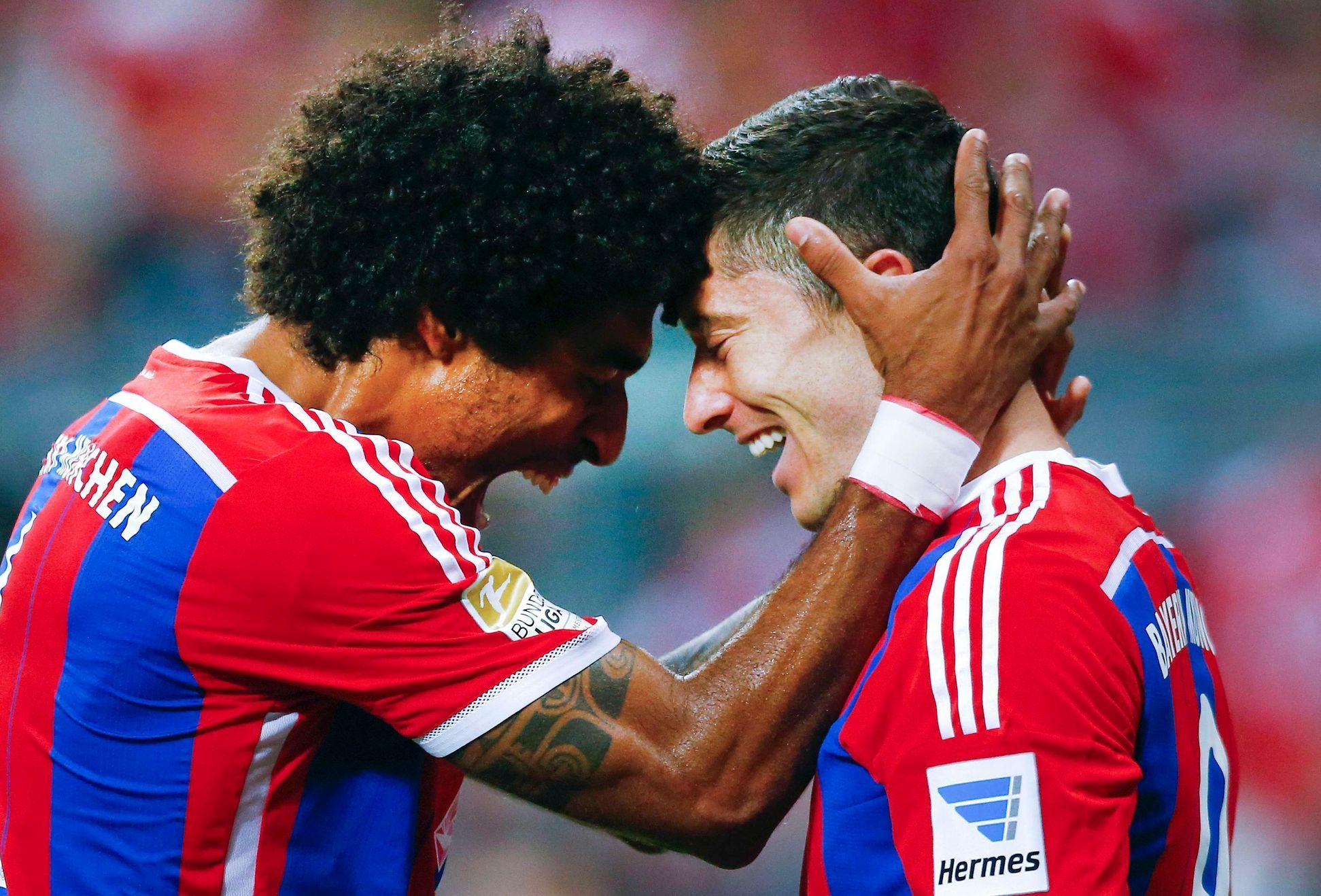 Bayern Munich's Lewandowski and Dante celebrate a goal against Paderborn during their German first division Bundesliga soccer match in Munich