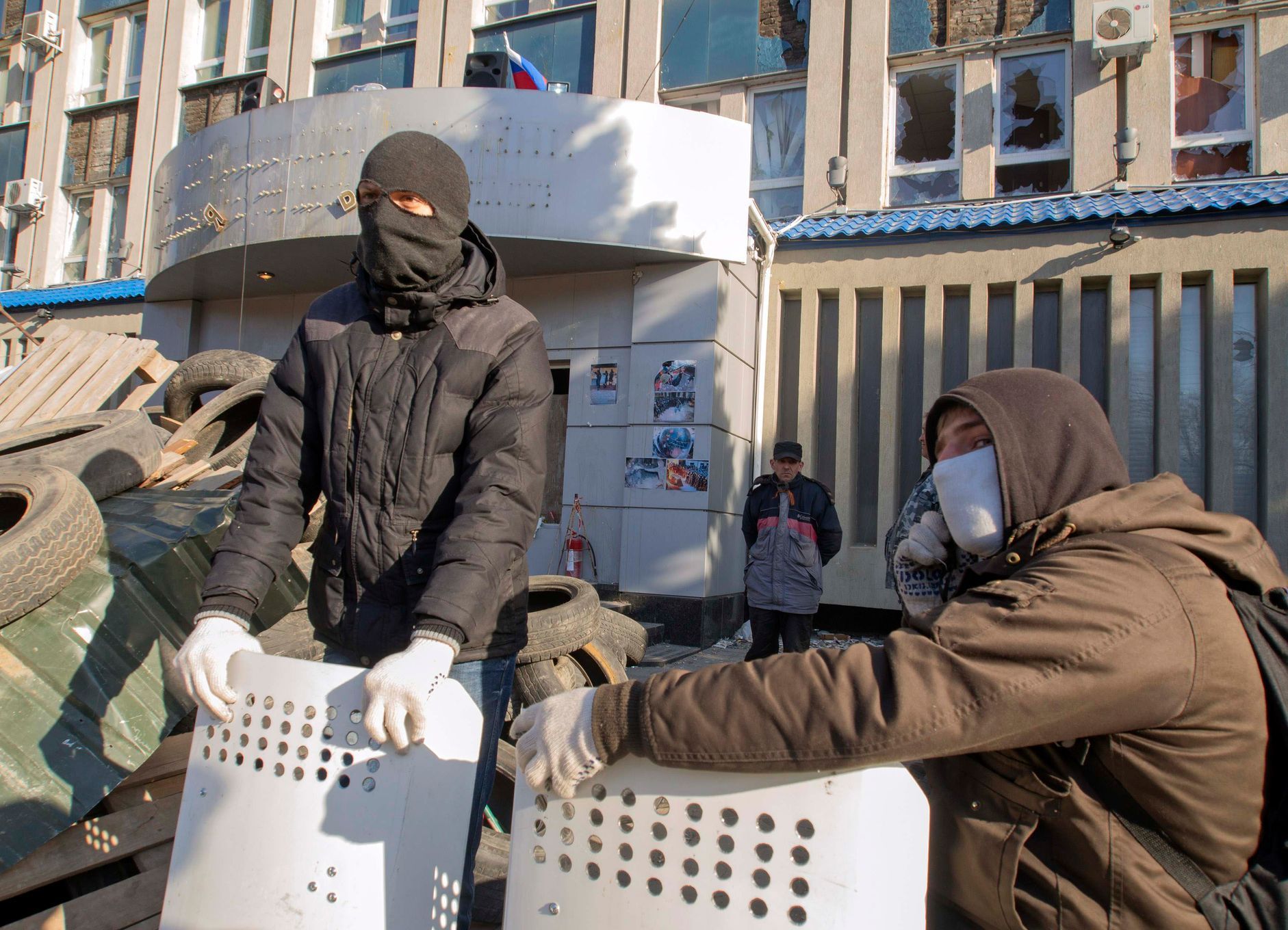 Pro-Russian protesters gather at a barricade outside the offices of the SBU state security service in Luhansk