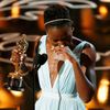 Nyong'o, best supporting actress winner for her role in &quot;12 Years a Slave&quot;, racts on stage at the 86th Academy Awards in Hollywood