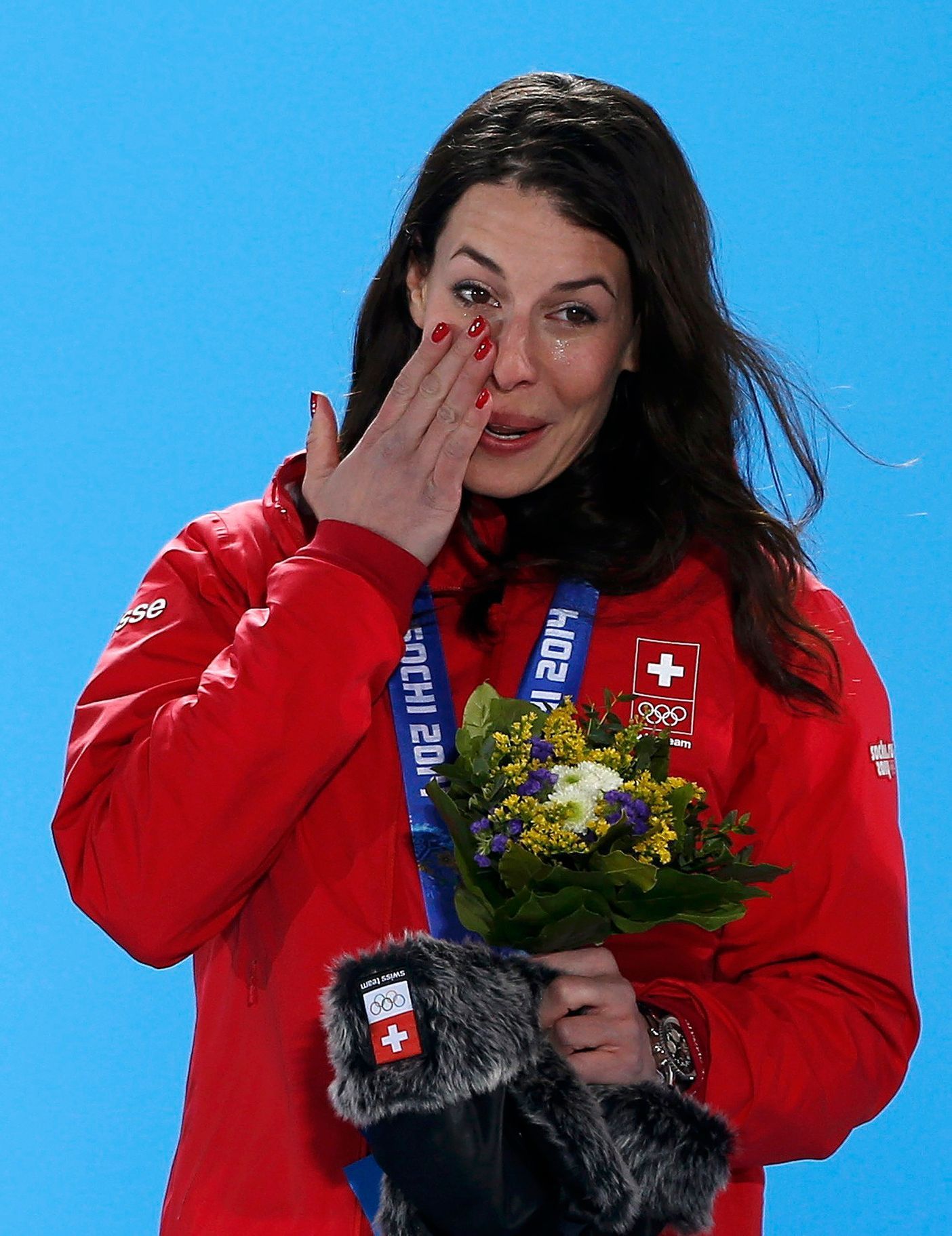 Gold medalist Switzerland's Gisin cries during the medal ceremony for the women's alpine skiing downhill race at the Sochi 2014 Winter Olympic Games in Sochi