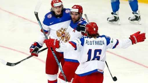 Russia's Danis Zaripov (C) celebrates his goal against Kazakhstan with team mates Sergei Plotinikov (R) and Viktor Tikhonov during the second period of their men's ice ho