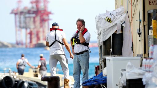 Salvage master Nick Sloane (R) talks on his mobile phone before boarding Costa Concordia cruise liner during the refloat operation at Giglio harbour at Giglio Island July