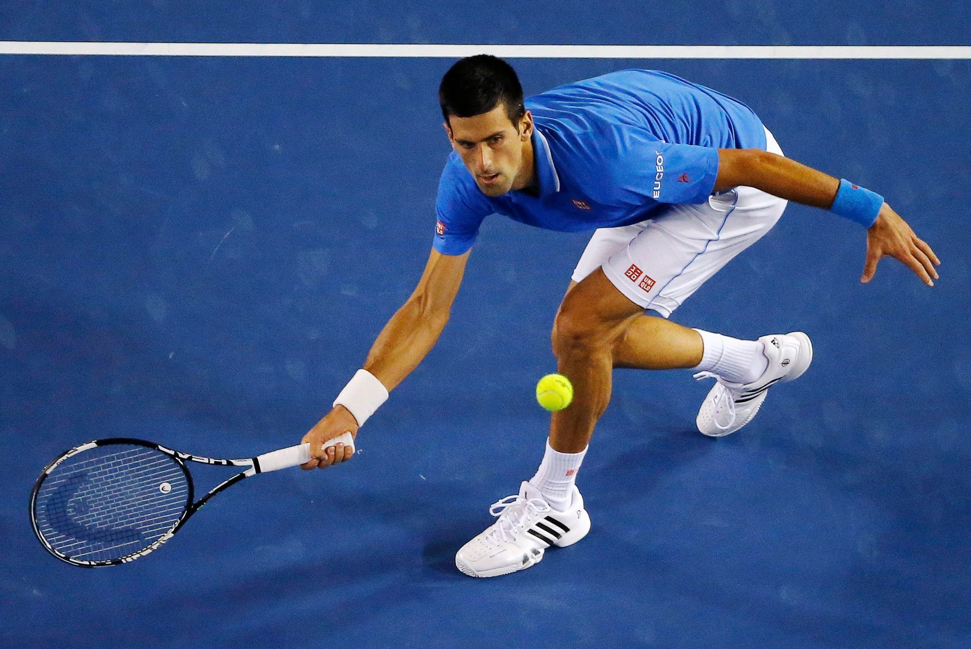 Djokovic of Serbia hits a return to Murray of Britain during their men's singles final match at the Australian Open 2015 tennis tournament in Melbourne