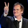 US director Quentin Tarantino flashes a victory sign as he arrives on the stage during the 39th Cesar Awards ceremony in Paris