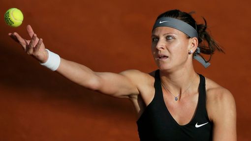 Lucie Safarova of the Czech Republic serves the ball to Mandy Minella of Luxembourg during their women's singles match at the French Open tennis tournament at the Roland