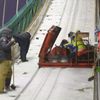 Officials and coaches work hard to freeze the in-run track of the ski jump slope ahead of a ski jumping competition at the FIS World Cup Ruka Nordic 2015 event in Kuusamo