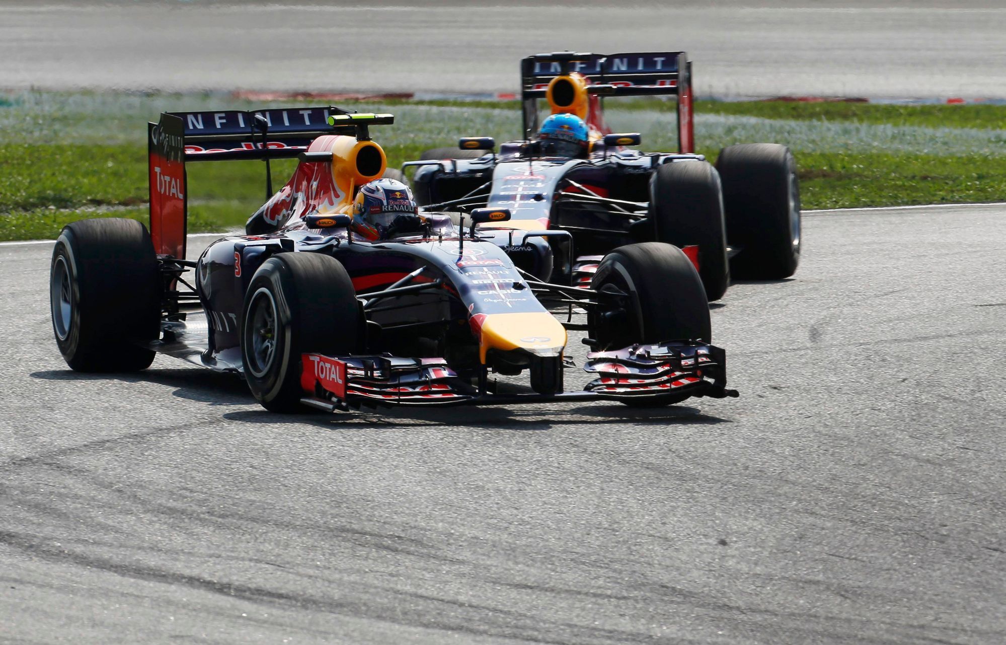 Red Bull Formula One driver Ricciardo drives ahead of team mate Vettel during the Malaysian F1 Grand Prix at Sepang International Circuit outside Kuala Lumpur