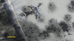 Still image taken from handout aerial footage shot by drone shows outline o airplane in the snow at the Sergey Prokofiev International Airport damaged by shelling during fighting between pro-Russian s