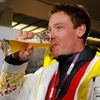 Germany's Loch drinks beer after winning the men's singles luge event at the 2014 Sochi Winter Olympics, in Rosa Khutor