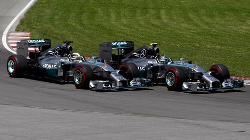Mercedes Formula One driver Nico Rosberg of Germany (R) cuts inside Mercedes Formula One driver Lewis Hamilton of Britain on the start during the Canadian F1 Grand Prix a