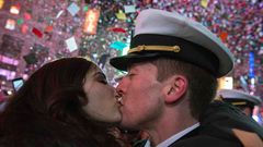 A couple kisses amid confetti as the clock strikes midnight during New Year's Eve celebrations in Times Square, New York