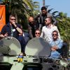 Cast members Victor Ortiz, Arnold Schwarzenegger, Victor Ortiz, Glen Powell and Antonio Banderas pose on a tank as they arrive on the Croisette to promote the film &quot;The Expendables 3&quot; during