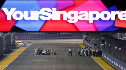 Mercedes Formula One driver Nico Rosberg of Germany has his car pushed back to the pit lane just before the start of the Singapore F1 Grand Prix at the Marina Bay street