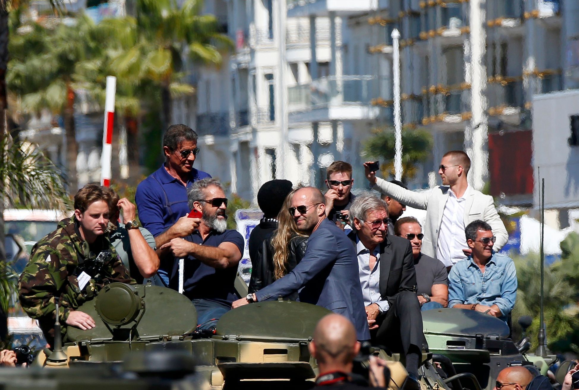 Cast members Sylvester Stallone, Mel Gibson, Jason Statham, Harrison Ford, Arnold Schwarzenegger and Antonio Banderas  pose on a tank as they arrive on the Croisette to promote the film &quot;The Expe