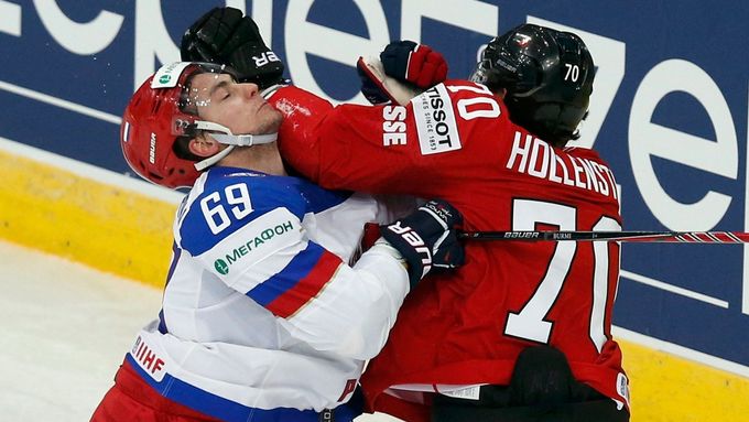 Russia's Alexander Burmistrov (L) clashes with Switzerland's Denis Hollenstein (R) during their men's ice hockey World Championship Group B game at Minsk Arena in Minsk M