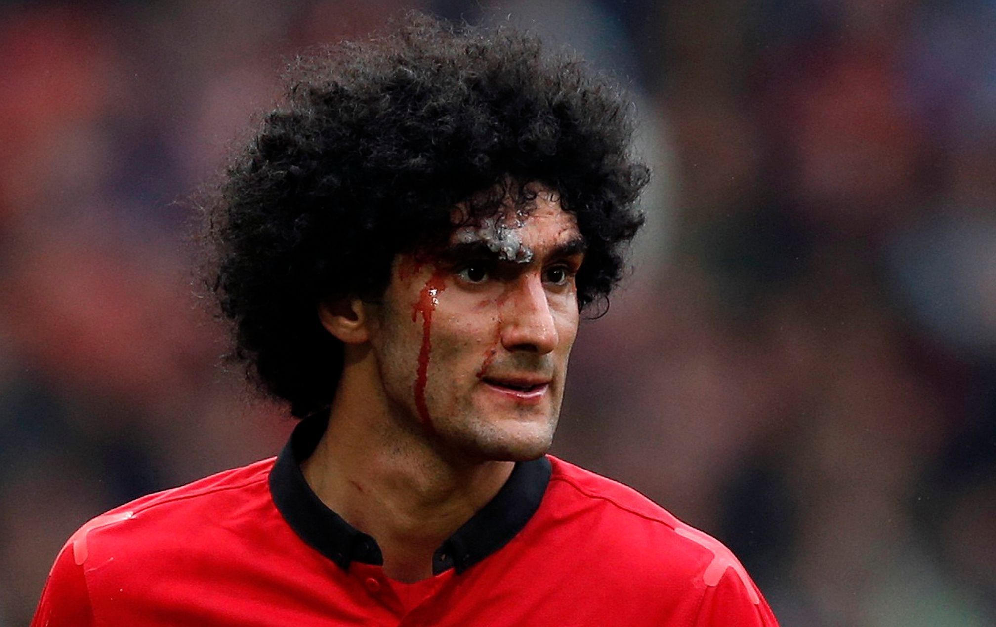 Manchester United's Fellaini bleeds from a head injury during their English Premier League soccer match against Liverpool in Manchester