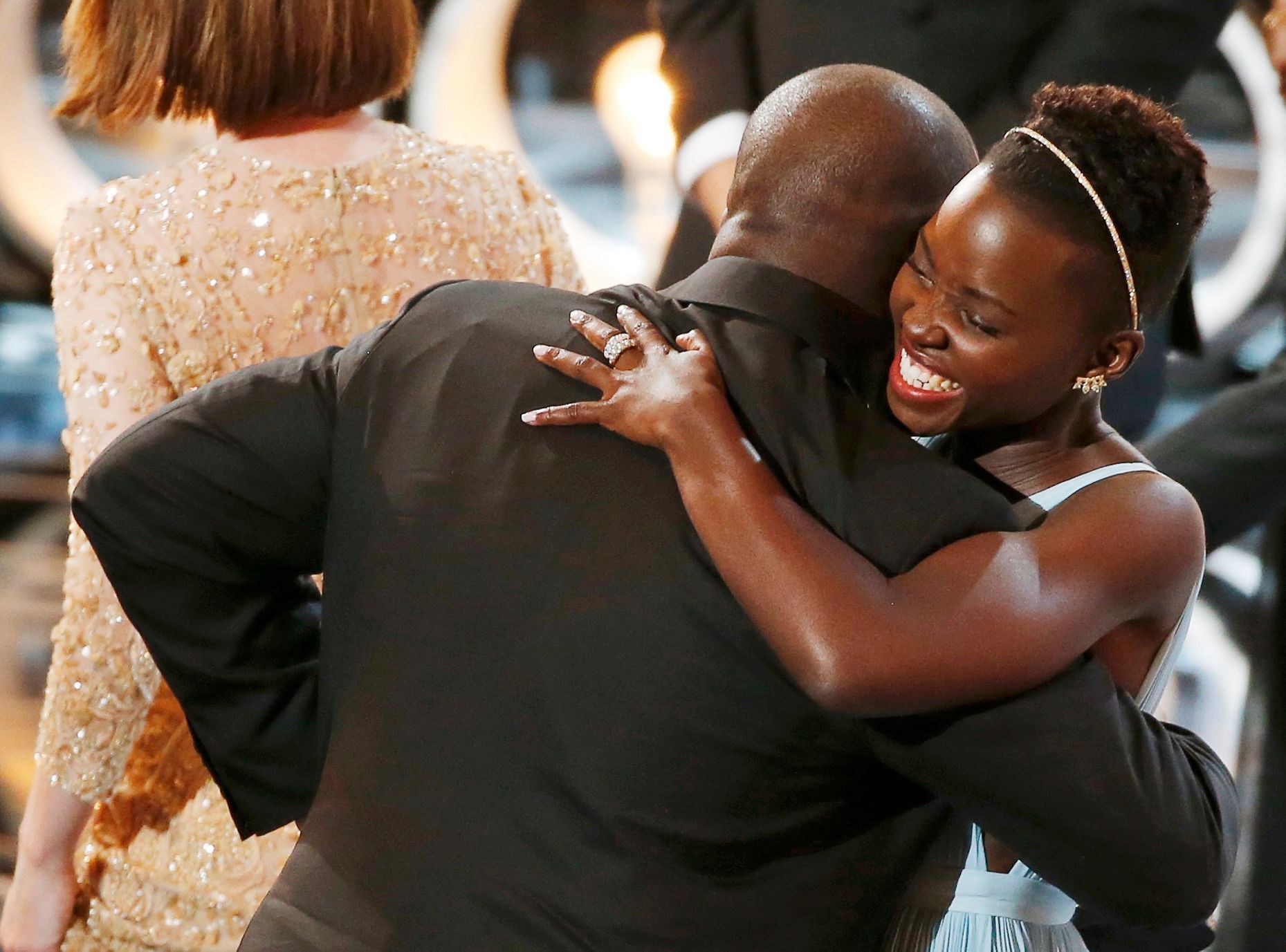 Director and producer McQueen celebrates with the Nyong'o after accepting the Oscar for best picture at the 86th Academy Awards in Hollywood