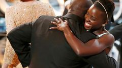 Director and producer McQueen celebrates with the Nyong'o after accepting the Oscar for best picture at the 86th Academy Awards in Hollywood