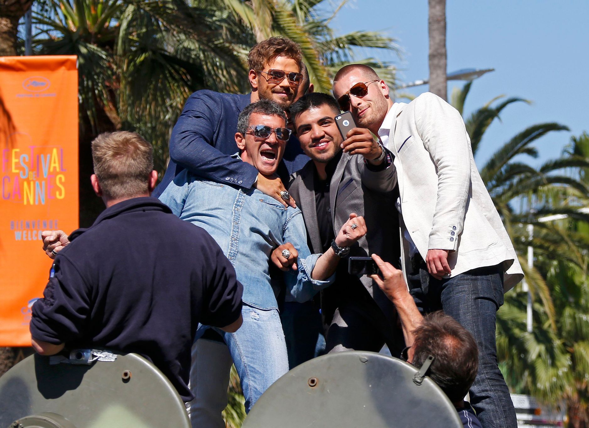 Cast members  Kellan Lutz, Antonio Banderas, Victor Ortiz and Glen Powell make a selfie with a mobile phone as they pose on a tank on the Croisette to promote the film &quot;The Expendables 3&quot; du