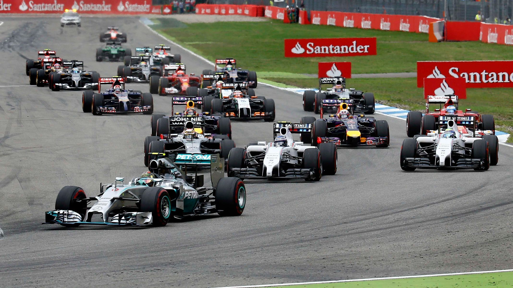 Mercedes Formula One driver Rosberg leads the race in the first corner after the start of the German F1 Grand Prix at the Hockenheim racing circuit