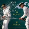 Race winner Mercedes Formula One driver Hamilton sprays champagne next to team mate second placed Rosberg during the podium ceremony of the Australian F1 Grand Prix at the Albert Park circuit in Melbo