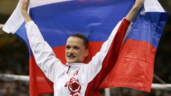 Russia's Svetlana Khorkina celebrates with her national flag