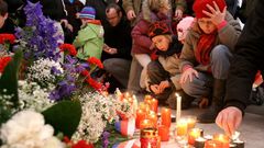 Děti zapalují svíčku u pomníku připomínající události 17.listopadu