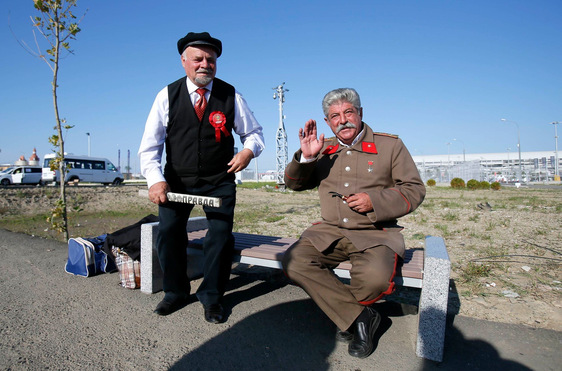 Men dressed as Soviet state founder Vladimir Lenin and Soviet leader Joseph Stalin pose for a picture in front of the paddock before the start of the Russian F1 Grand Prix in the Sochi Autodrom circui