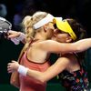Caroline Wozniacki of Denmark is congratulated by Agnieszka Radwanska of Poland during WTA Finals singles tennis match at the Singapore Indoor Stadium