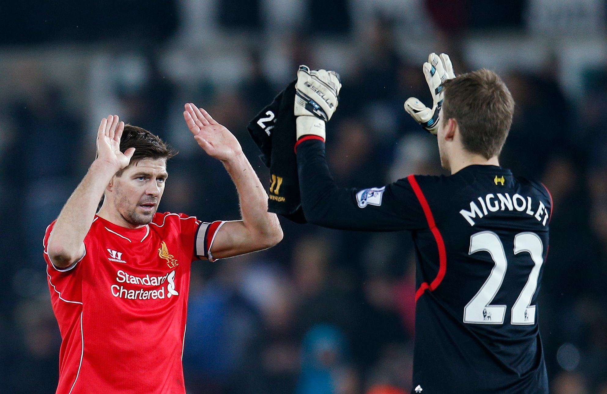 Football: Liverpool's Steven Gerrard and Simon Mignolet celebrate victory