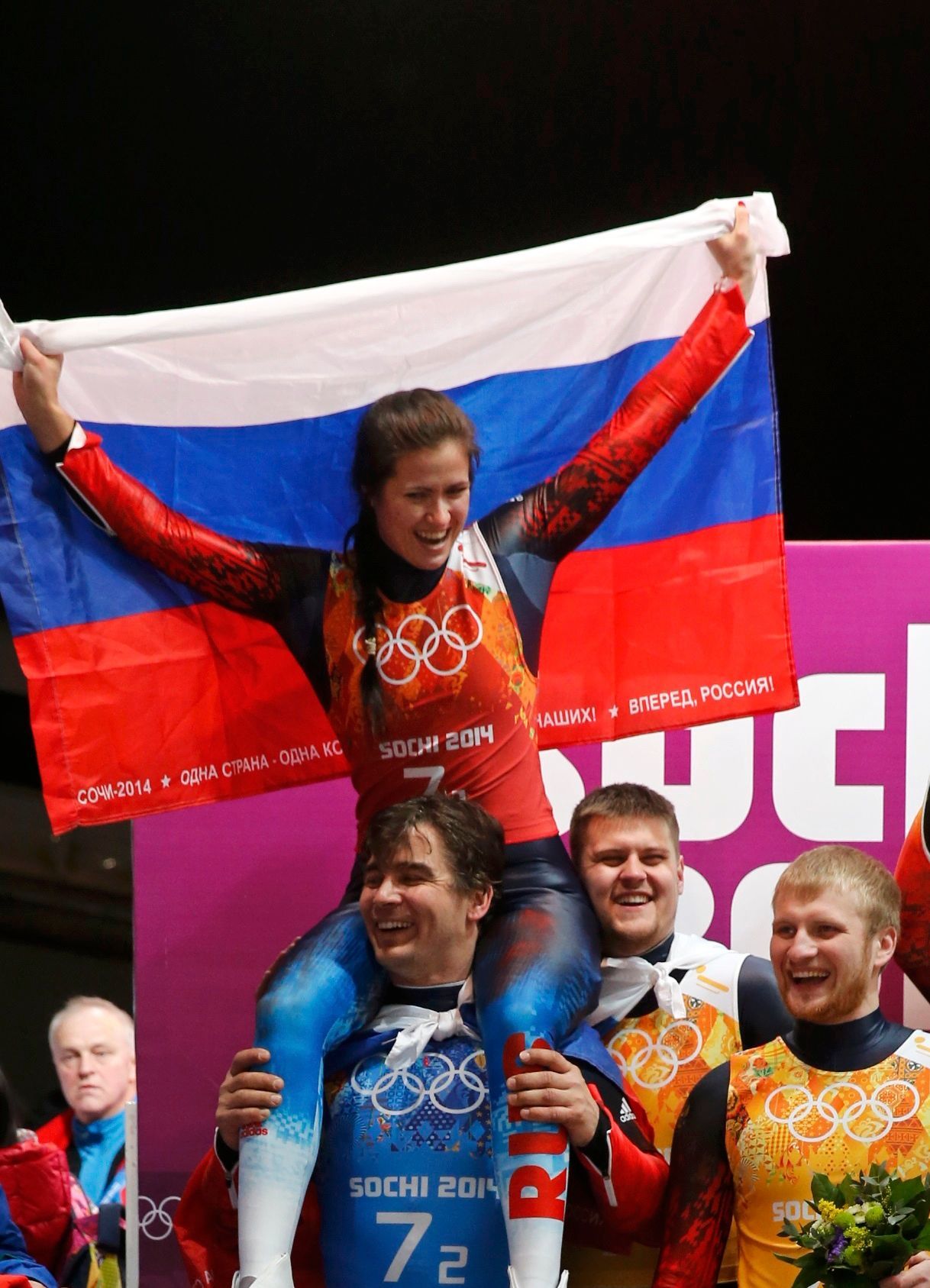 Russia's Demchenko, Ivanova, Antonov and Denisyev celebrate their second place in the luge team relay competition at the 2014 Sochi Winter Olympics