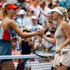 Caroline Wozniacki (R) of Denmark shakes hands with Maria Sharpova of Russia after defeating her at the 2014 U.S. Open tennis tournament in New York