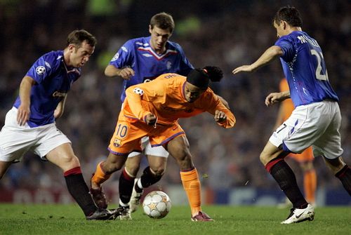 Barcelonský Ronaldinho se snaží prosadit mezi hráči Glasgowu Rangers. | Foto: Reuters