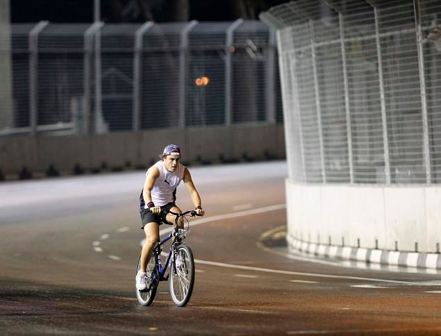 Fernando Alonso na kole. Nezměnil stroj, ale tak si prohlíží trať v Singapuru | Foto: Reuters