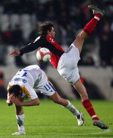 Německý fotbalista Manuel Friedrich v souboji s Kypřanem Michaelem Constantinouem v kvalifikačním utkání o postup na EURO 2008. | Foto: Reuters