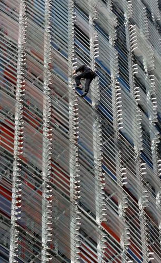 Francouzský horolezec a dobrodruh Alain Robert, přezdívaný Spiderman, proslul výstupem na výškové budovy po celém světě. Včera zdolal 114 metrů vysokou AGBA Tower v Barceloně. V minuosti se vyšplhal i na Eiffelovu věž a Empire State Building. | Foto: ČTK/AP