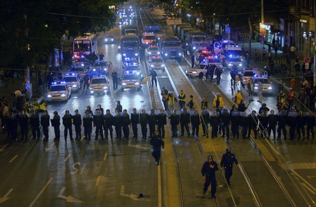 Policisté se v Budapešti řadí do formace a chystají se rozehnat protestující dav. | Foto: Reuters